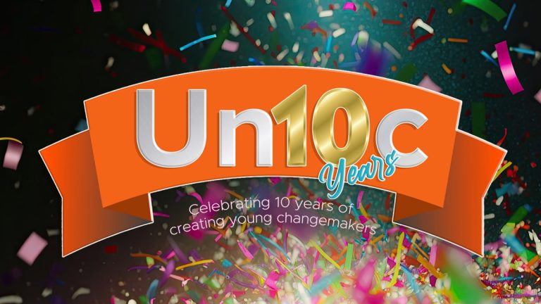 Orange ribbon banner with Un10c Years in large text, surrounded by confetti. Subtext reads: Celebrating 10 years of creating young changemakers.