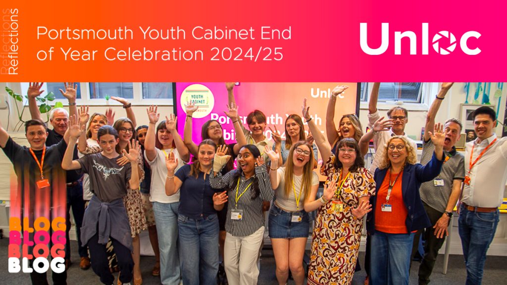 A diverse group of young people celebrates together indoors under a sign reading Portsmouth Youth Cabinet End of Year Celebration 2024/25 with Unloc branding.