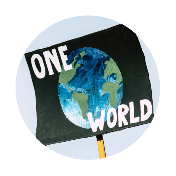 A protest sign with a painting of Earth and the words ONE WORLD on a black background.