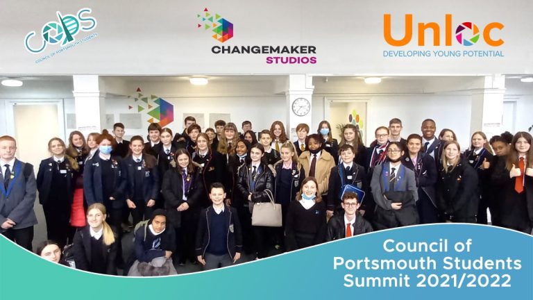 A large group of students in school uniforms poses indoors at the Council of Portsmouth Students Summit 2021/2022, with event logos displayed above them.