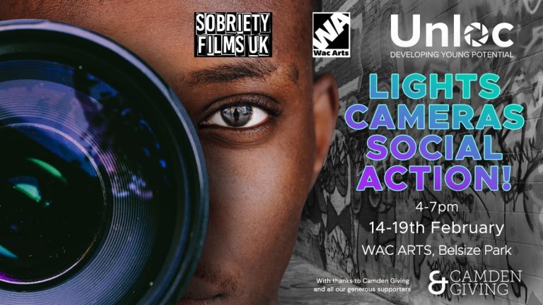 A man looking through a camera lens.