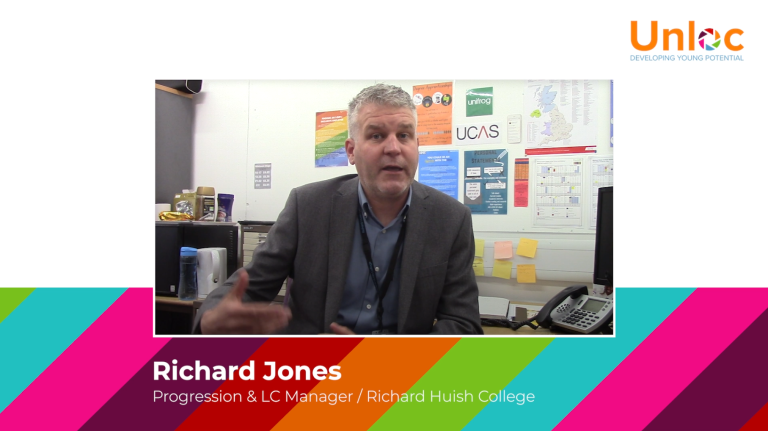 A man in a grey blazer sits in an office, speaking. The background shows posters, a desk phone, and office supplies. Text on the image identifies him as Richard Jones from Richard Huish College.