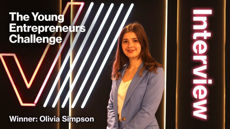A woman in a blue blazer stands in front of neon lights and text reading The Young Entrepreneurs' Challenge, Interview, and Winner: Olivia Simpson.